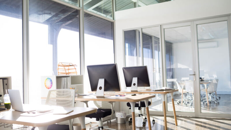 Laptop and computer on table in office